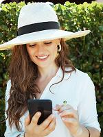 Woman in a sun hat looking at her phone