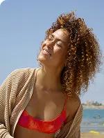 Woman with curly hair enjoying the sunshine